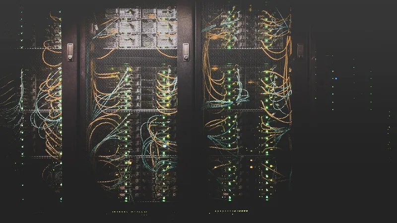 Rows of server racks and network cables in a data centre